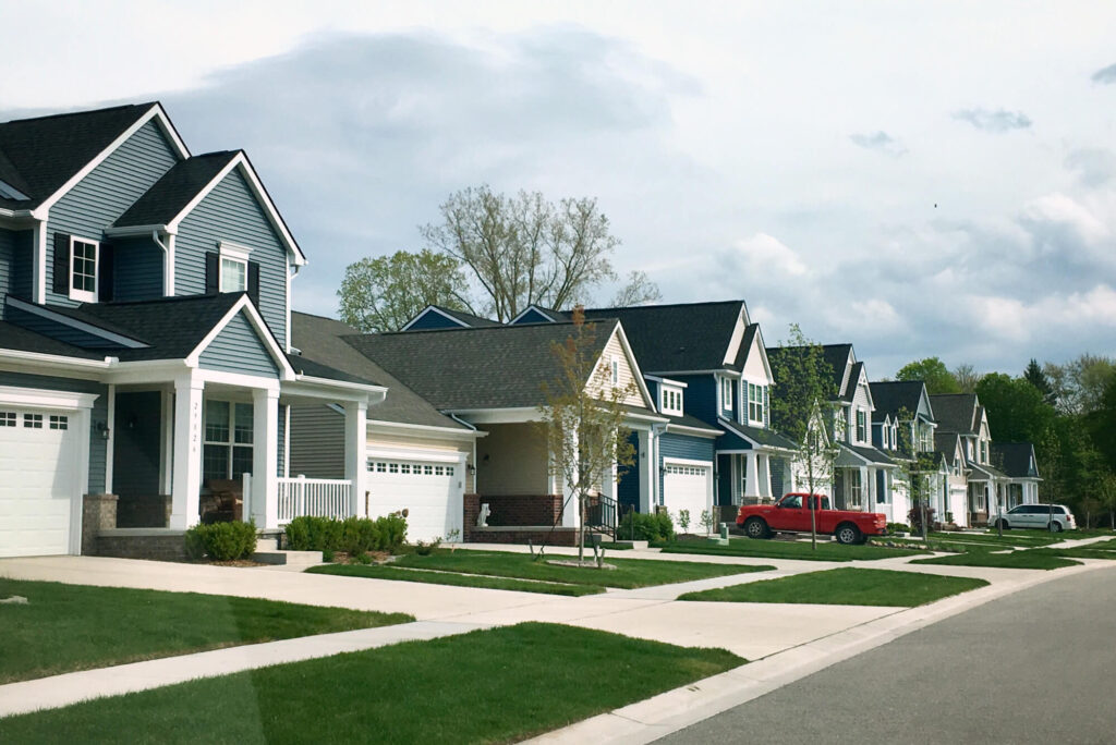 A row of houses on the side of a street.